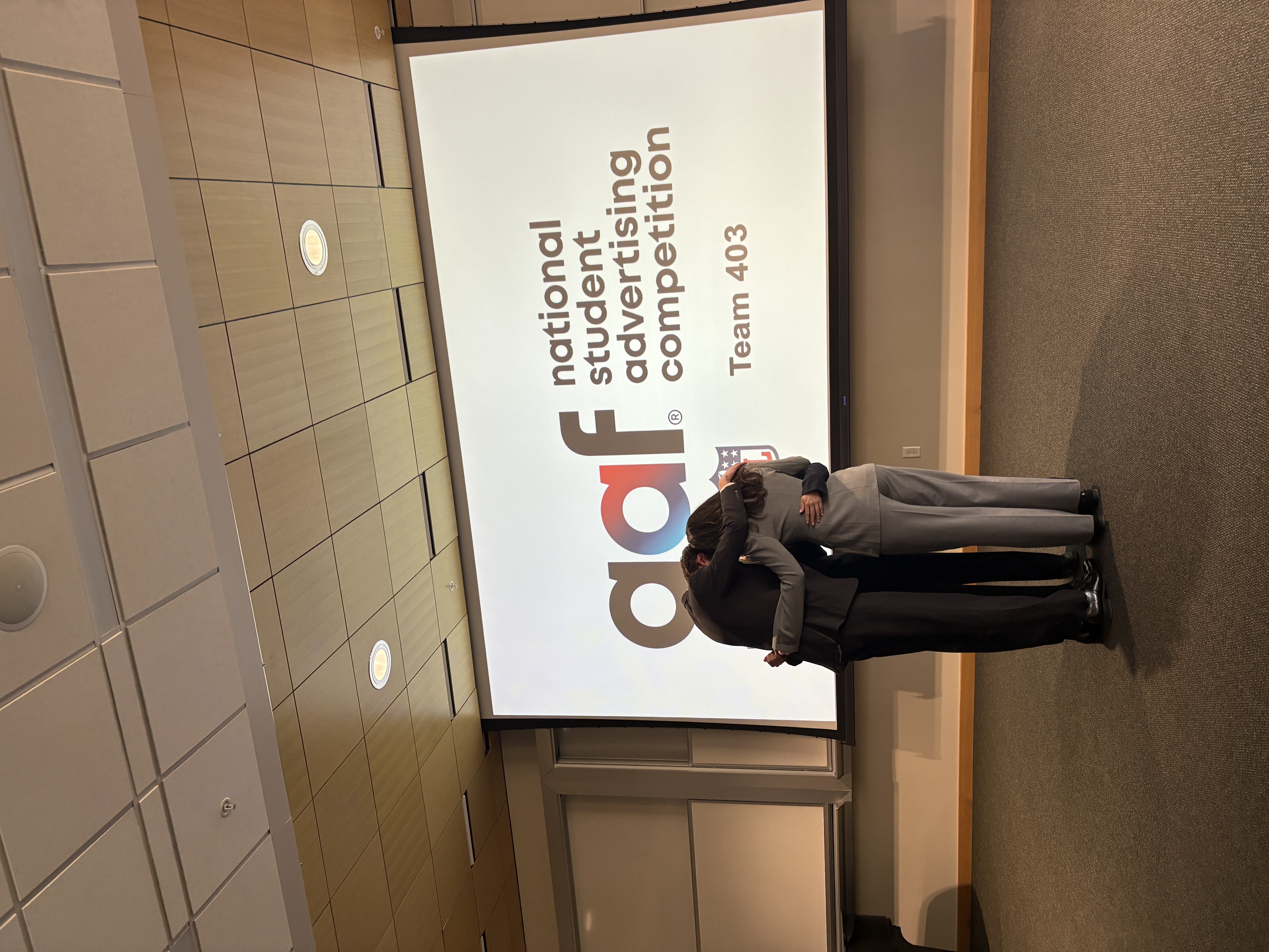 Bryce presenting with the National Student Advertising Competition slide behind him